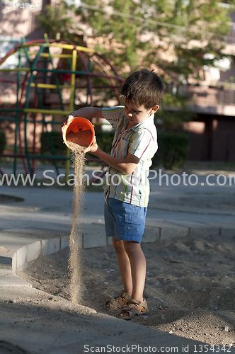 Image of Children pour sand