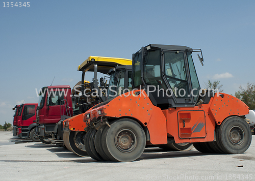 Image of Trucks, rollers and machinery for asphalting