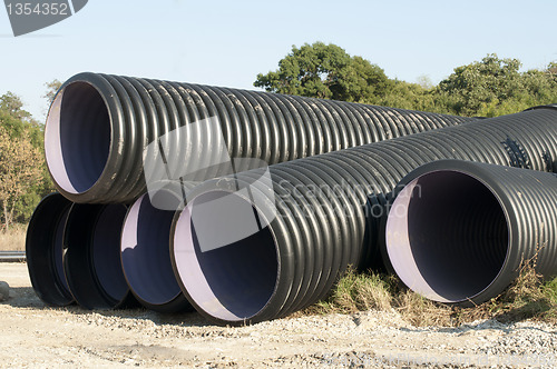 Image of Pipes and piles of sand in the background