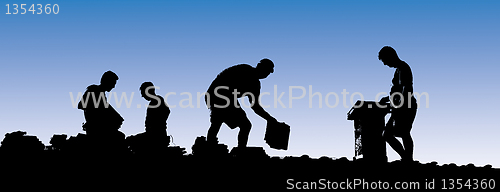 Image of Construction workers put shingles on a roof