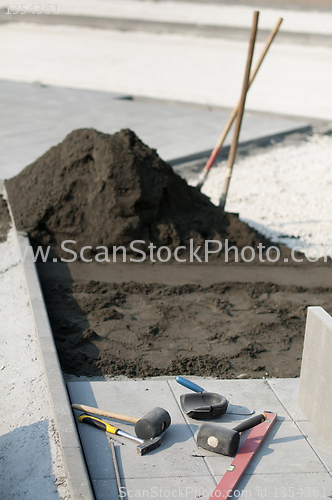 Image of Tiling of pavement and sand pile