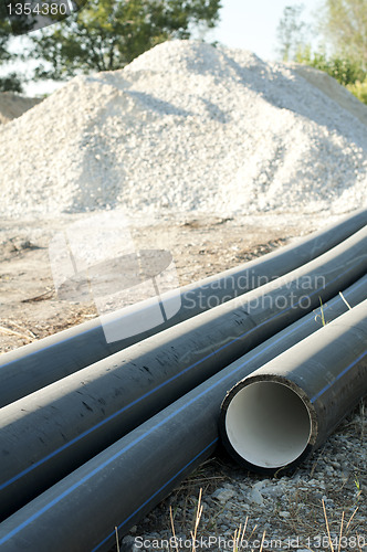 Image of Pipes and piles of sand in the background