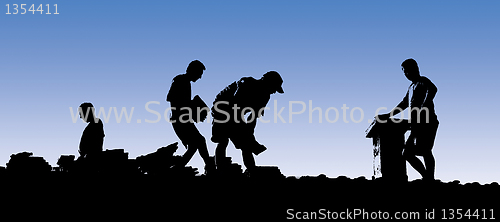 Image of Construction workers put shingles on a roof