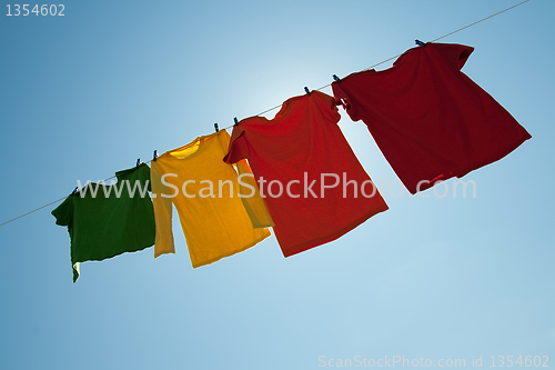 Image of Sunshine behind colorful clothes on a laundry line