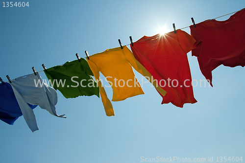 Image of Sun shining over a laundry line with bright clothes