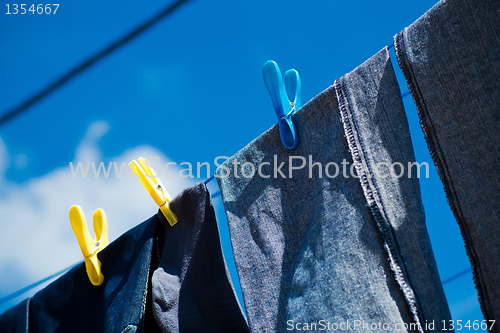 Image of Washed blue jeans drying outside