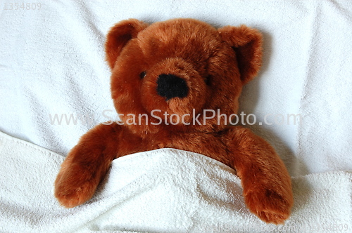 Image of sick teddy with injury in bed