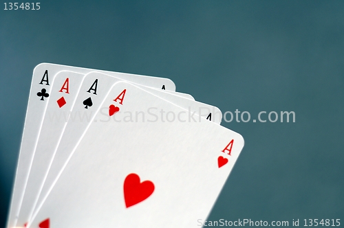 Image of hand holding four aces