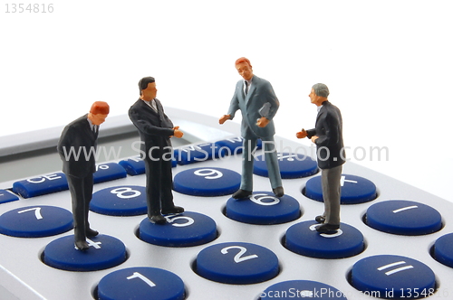 Image of business people on calculator isolated