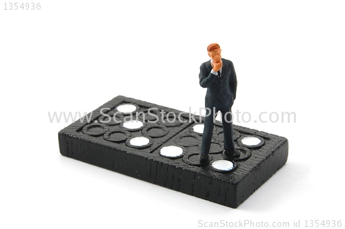 Image of business man on domino isolated