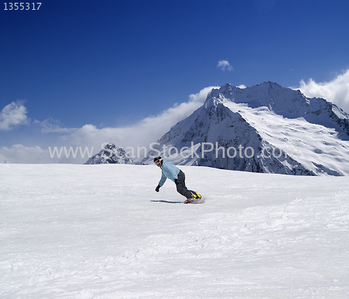 Image of Snowboarder descends a slope