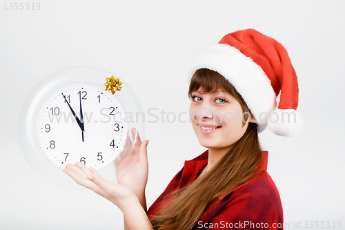 Image of attractive girl with a clock