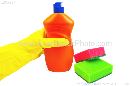 Image of Bottle of orange with a yellow-gloved hand and sponges