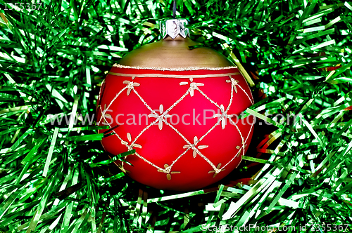Image of Christmas red ball on the green tinsel