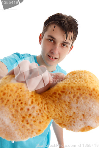Image of Teenager with outstretched hand holding a soapy sponge