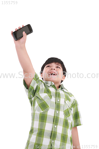 Image of boy holding up cellular phone and smiling