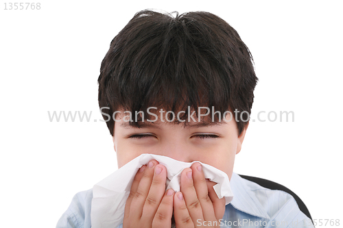 Image of sick boy blowing his nose, white background  