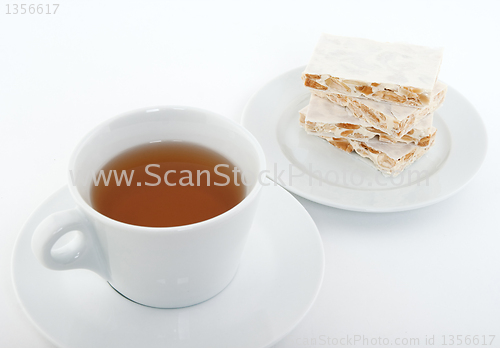 Image of Cup of tea and Spanish turron for dessert