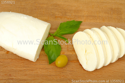 Image of mozzarella cheese on a wooden background