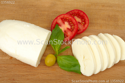 Image of mozzarella cheese on a wooden background