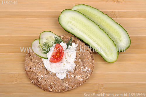 Image of crispbread with curd cheese with cucumber and tomato