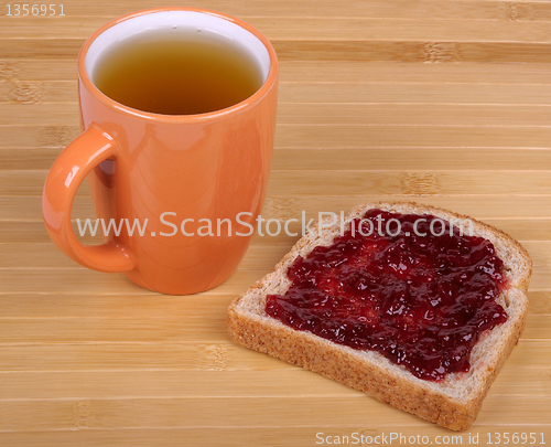 Image of cup of tea and a sandwich with jam