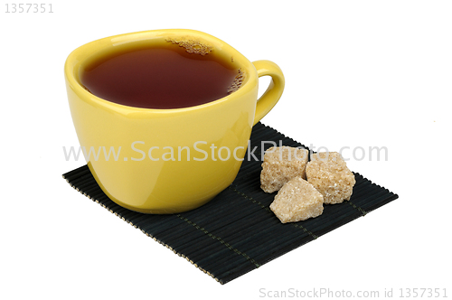 Image of tea and sugar cane on the mat