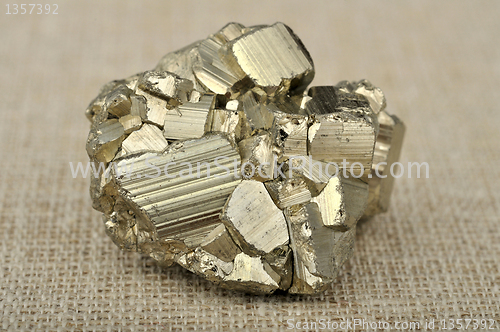 Image of pyrite in the background of a burlap