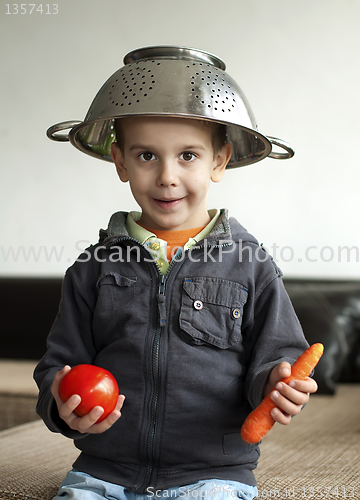 Image of Boy with tomato and carrot in hand
