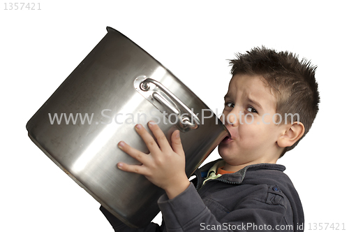 Image of Child drinking milk from a big saucepan