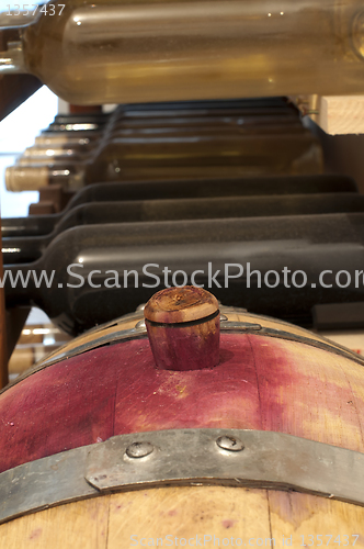 Image of A little wine barrel and bottles wine