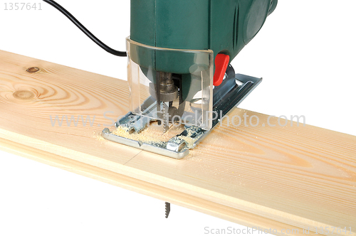 Image of sawing wood board electric jigsaw