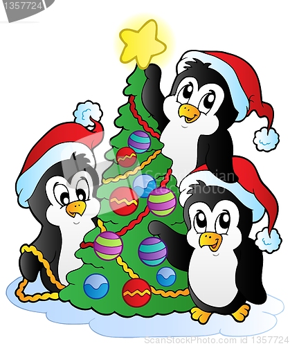 Image of Three penguins with Christmas tree