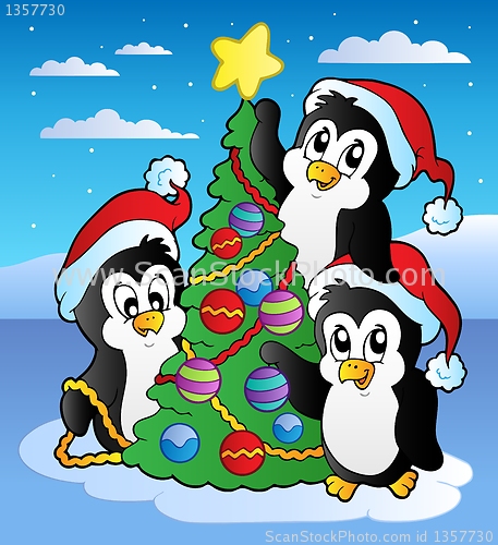 Image of Christmas scene with three penguins