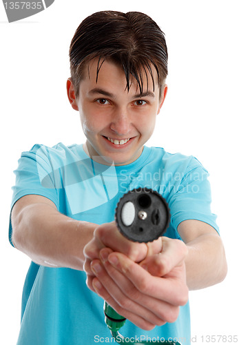 Image of Cheeky boy pointing a garden hose