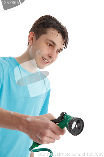 Image of Boy using a garden hose