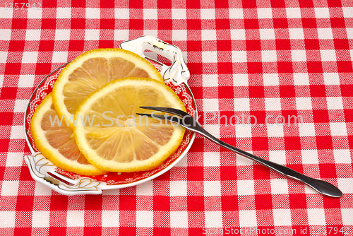 Image of lemon on a plate with a fork