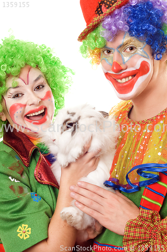 Image of Two cheerful clown with a white rabbit