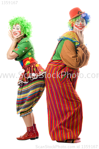 Image of Two smiling clowns are back to back