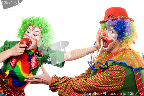 Image of Clowns are fighting for an apple