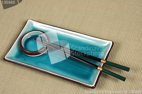 Image of Plate, dipping bowl and chop sticks on green mat