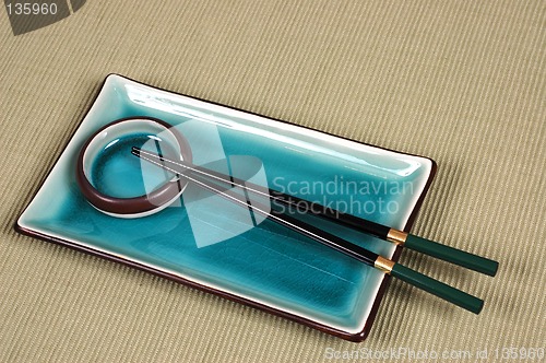 Image of Plate, dipping bowl and chop sticks on green mat
