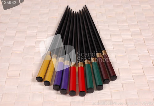 Image of Multi colored chop sticks on mat
