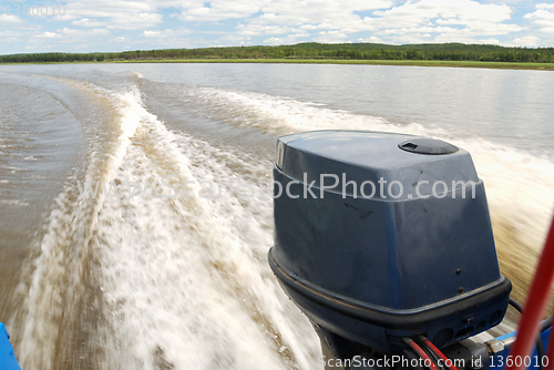Image of outboard motor boat on the river