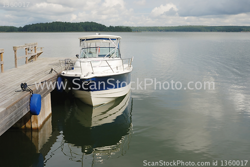 Image of big white boat tied up at the seashore