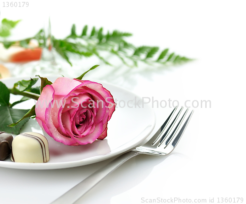 Image of rose and candy on a plate