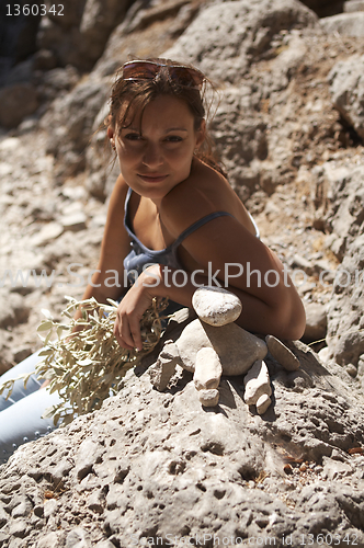 Image of Young Woman Built Stone Stacks