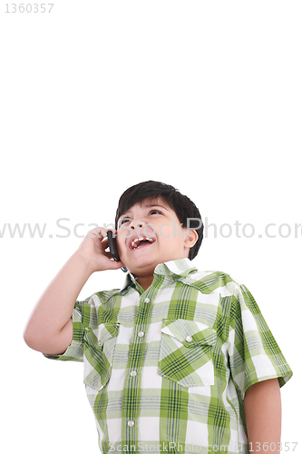 Image of Beautiful little boy  laughs and talks by mobile phone. 