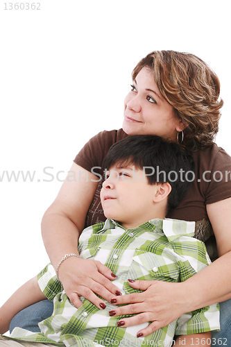 Image of little boy looking something interesting to his mother against w