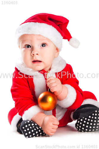Image of little cute baby gnome in red with golden ball